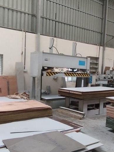 Panel stock and sheet materials staged in the Padmodya workshop