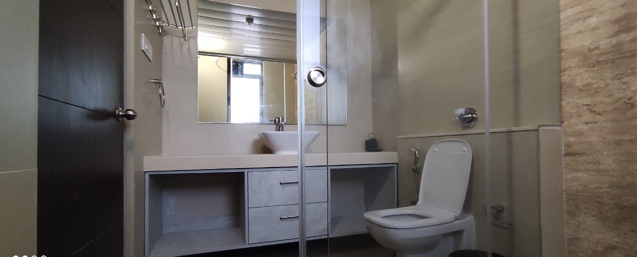 Bathroom vanity with a mirrored storage unit, by Padmodya Interiors
