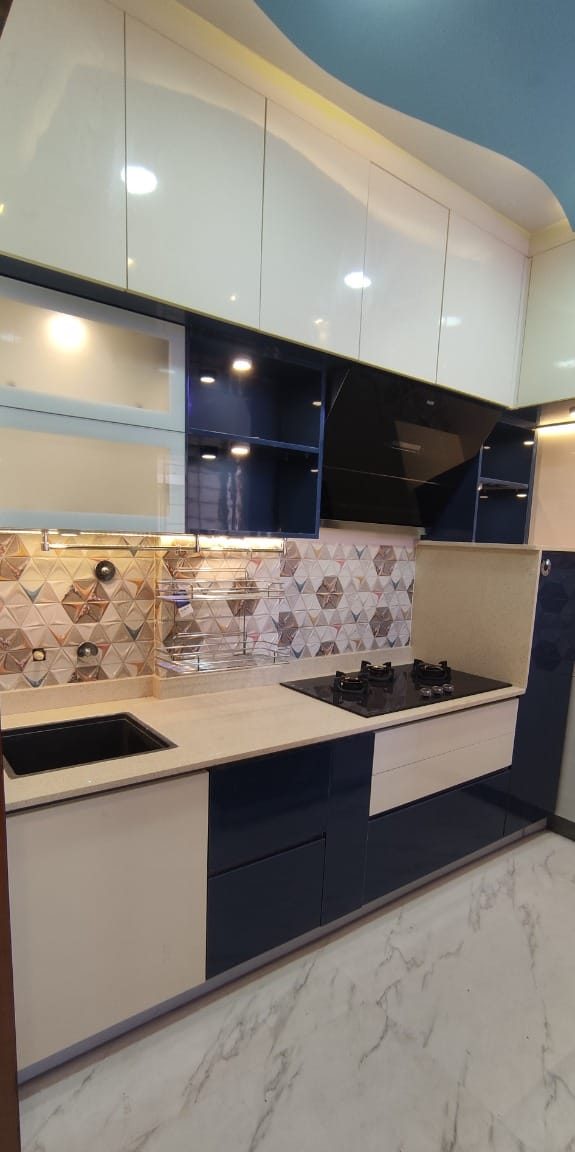 Modular kitchen in indigo and cream, by Padmodya Interiors
