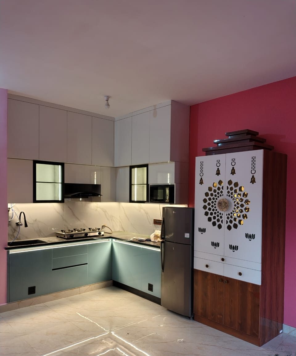 Modular kitchen with a fitted pooja unit, by Padmodya Interiors