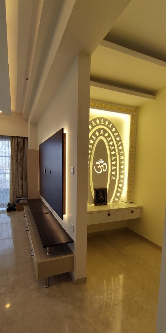 Backlit pooja unit off the living hall, by Padmodya Interiors