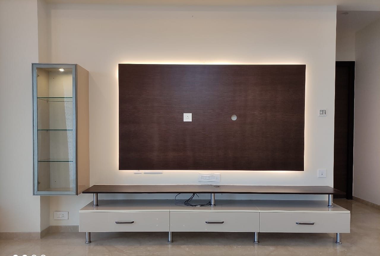 Backlit walnut television unit, by Padmodya Interiors