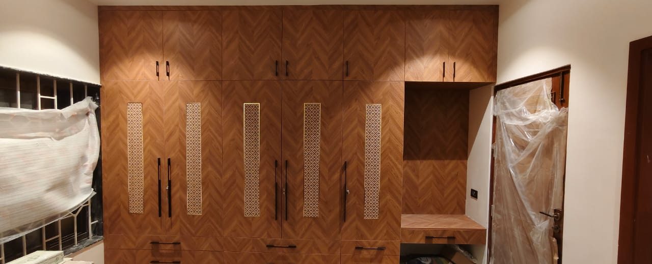 Herringbone wardrobe with fluted inserts, by Padmodya Interiors