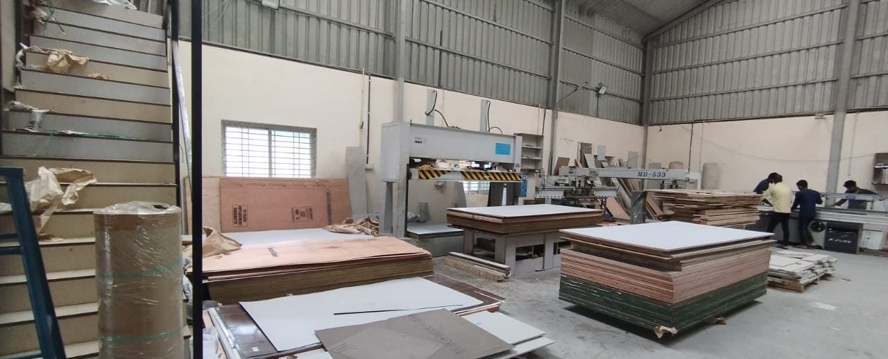 The Padmodya workshop floor, with panel stock and the production team at work
